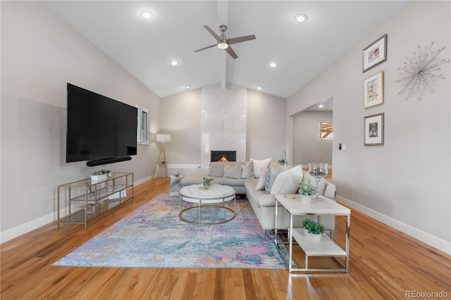 7155 E Exposition Ave, Denver, CO 80224 - living area with vaulted ceiling, a ceiling fan, wood finished floors, a fireplace, and recessed lighting