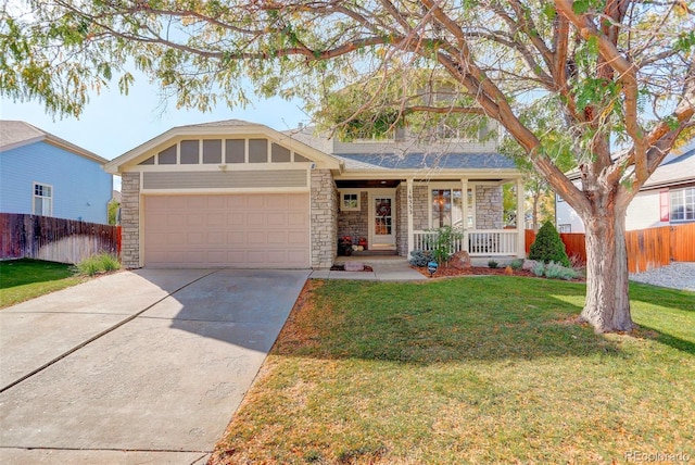 view of front of home featuring a front lawn, fence, stone siding, and a garage