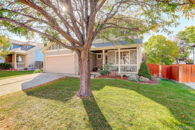 view of front of home with a porch, concrete driveway, fence, and stone siding