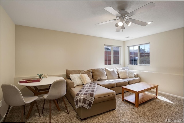 living room with visible vents, ceiling fan, carpet floors, and baseboards