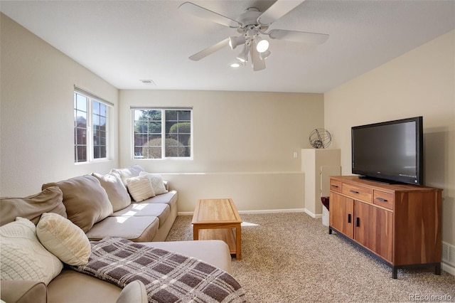living room featuring visible vents, baseboards, a ceiling fan, and light colored carpet