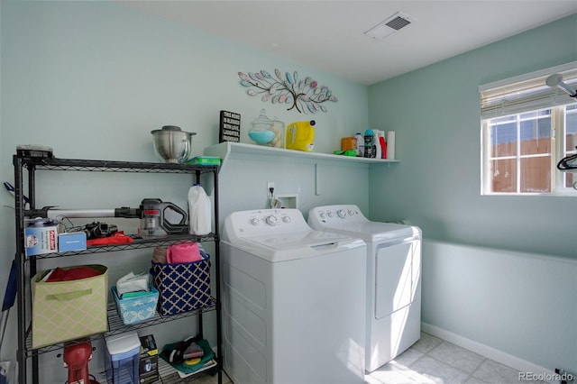 washroom featuring laundry area, separate washer and dryer, baseboards, and visible vents