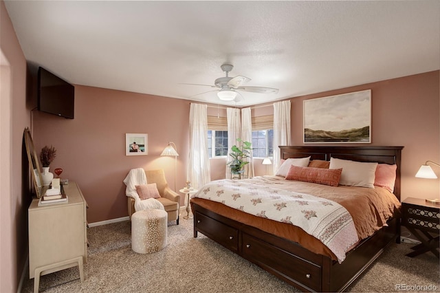 bedroom featuring ceiling fan, light carpet, and baseboards