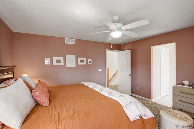 bedroom with carpet flooring, visible vents, baseboards, and ceiling fan