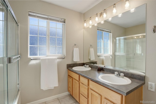 full bathroom with a sink, a wealth of natural light, and a shower with door