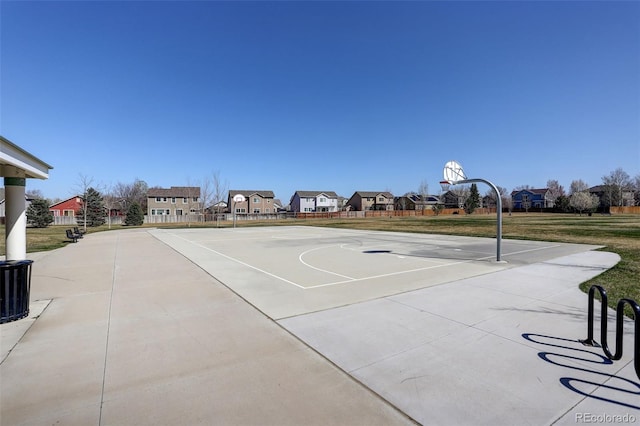 view of sport court with community basketball court, a residential view, and a lawn
