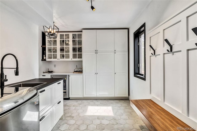 7388 S Ireland Cir, Centennial, CO 80016 - kitchen with a chandelier, glass insert cabinets, white cabinets, and hanging light fixtures