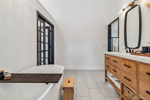 7388 S Ireland Cir, Centennial, CO 80016 - bathroom with a freestanding tub, double vanity, and tile patterned floors