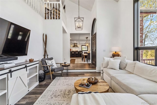 7388 S Ireland Cir, Centennial, CO 80016 - living room with dark wood-style flooring, a chandelier, and a towering ceiling