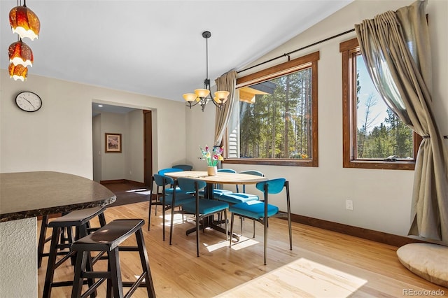 209 American Way, Breckenridge, CO 80424 - dining space featuring a chandelier, light wood-style flooring, and vaulted ceiling