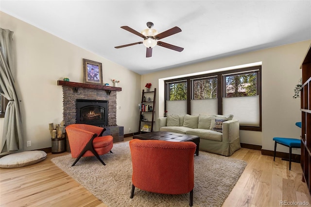 209 American Way, Breckenridge, CO 80424 - living room featuring light wood-style flooring, a stone fireplace, ceiling fan, and lofted ceiling