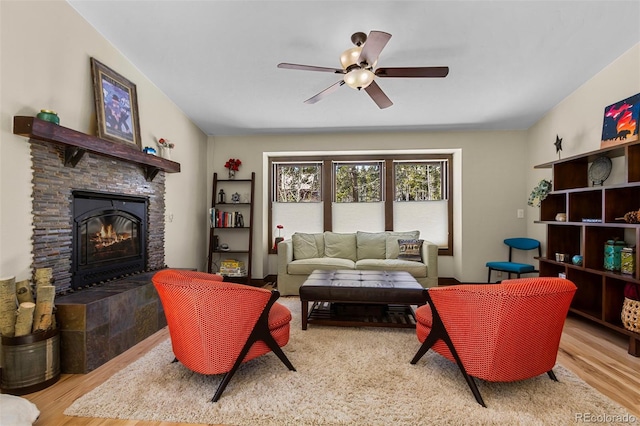 209 American Way, Breckenridge, CO 80424 - living area with wood finished floors, a stone fireplace, and a ceiling fan