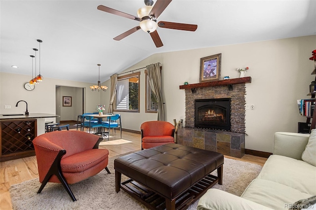 209 American Way, Breckenridge, CO 80424 - living area with ceiling fan, light wood-style flooring, lofted ceiling, a stone fireplace, and a chandelier