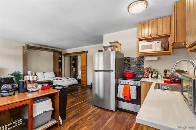 209 American Way, Breckenridge, CO 80424 - kitchen with appliances with stainless steel finishes, light countertops, dark wood-style floors, open floor plan, and brown cabinets