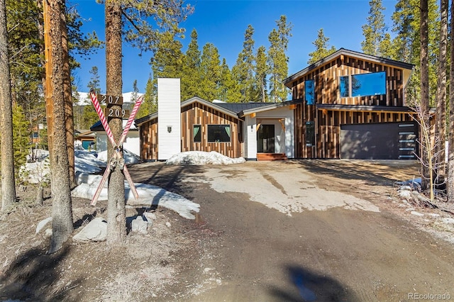 209 American Way, Breckenridge, CO 80424 - view of front facade featuring board and batten siding, driveway, a garage, and a metal roof