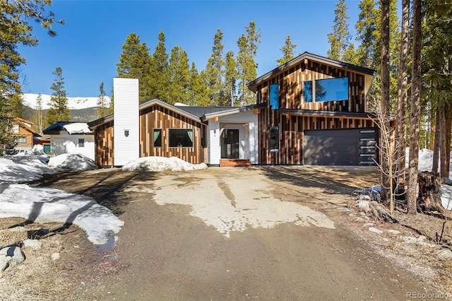 209 American Way, Breckenridge, CO 80424 - view of front of home with driveway, a garage, a chimney, and a metal roof