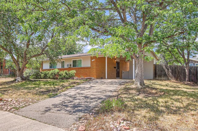 single story home featuring a front lawn and a carport