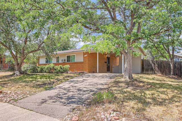 ranch-style home with a carport and a front yard