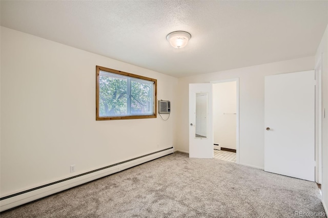 unfurnished bedroom with a textured ceiling, light carpet, a wall mounted air conditioner, and baseboard heating