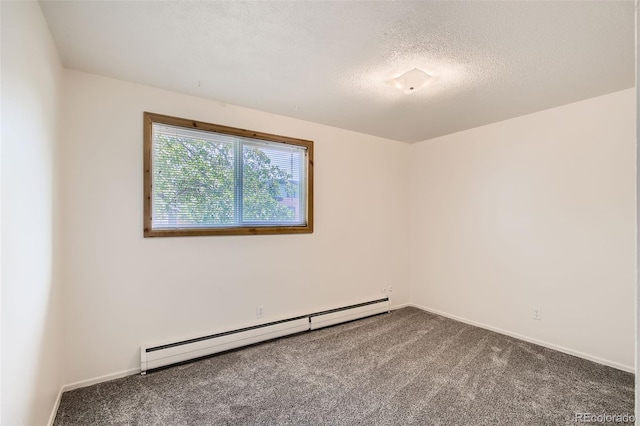 carpeted empty room with baseboard heating and a textured ceiling