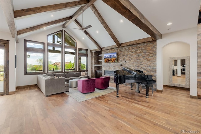 living area with high vaulted ceiling, ceiling fan, beamed ceiling, and wood finished floors