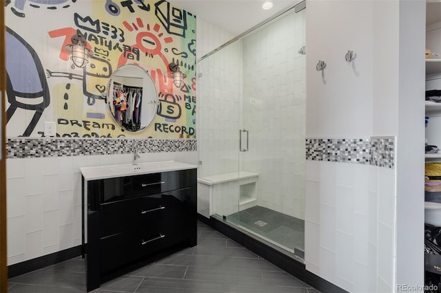 bathroom featuring vanity, tile walls, a stall shower, and tile patterned floors