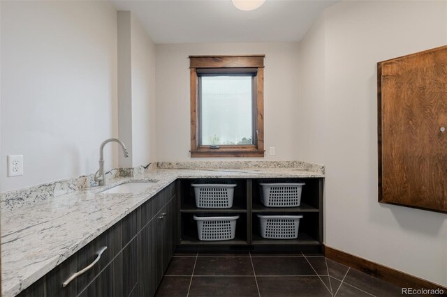 bathroom with baseboards, tile patterned flooring, and vanity