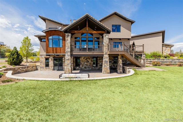 rear view of property featuring a yard, a patio, stairway, and stone siding