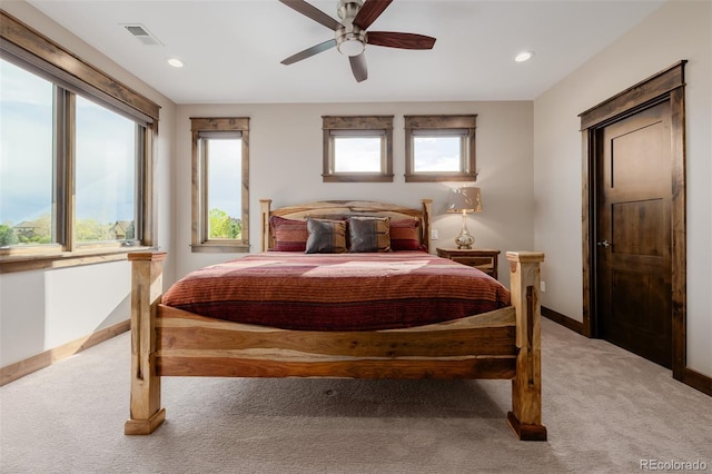 bedroom featuring ceiling fan, visible vents, baseboards, light carpet, and recessed lighting
