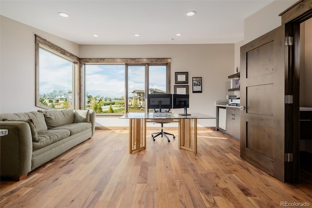 office with recessed lighting and light wood-style flooring
