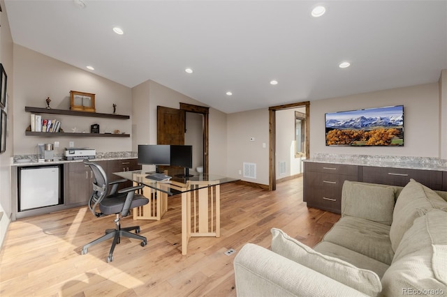 office featuring visible vents, vaulted ceiling, baseboards, light wood-style floors, and recessed lighting