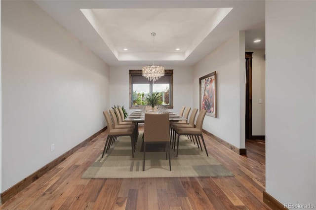 2466 Spruce Meadows Dr, Broomfield, CO 80023 - dining space with a chandelier, baseboards, a tray ceiling, wood finished floors, and recessed lighting