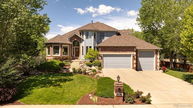 3935 Pierson St, Wheat Ridge, CO 80033 - view of front facade with a garage, concrete driveway, brick siding, and a shingled roof