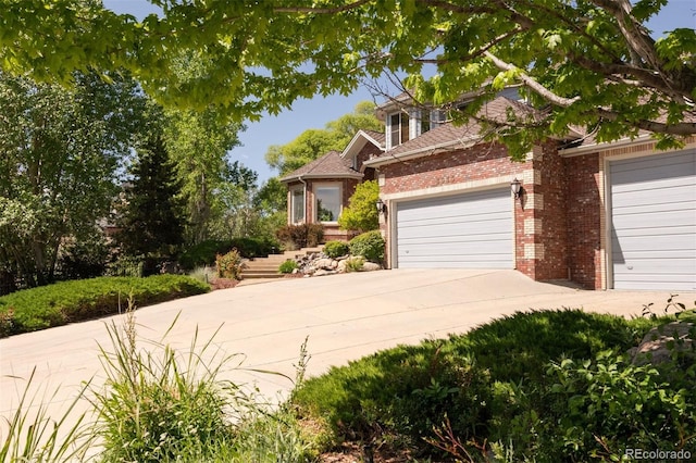 3935 Pierson St, Wheat Ridge, CO 80033 - view of front of property with brick siding, driveway, and an attached garage