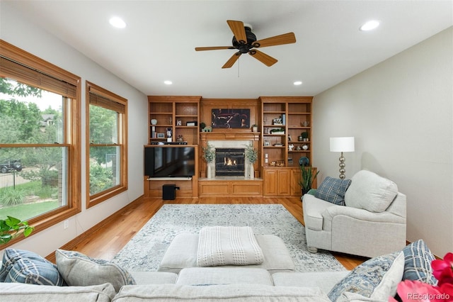 3935 Pierson St, Wheat Ridge, CO 80033 - living room with recessed lighting, a fireplace, a ceiling fan, and light wood-style flooring