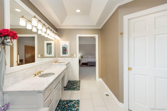 3935 Pierson St, Wheat Ridge, CO 80033 - ensuite bathroom featuring double vanity, tile patterned flooring, crown molding, and a tray ceiling