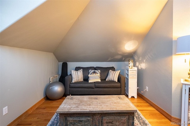 3935 Pierson St, Wheat Ridge, CO 80033 - living room featuring light wood finished floors, vaulted ceiling, and radiator heating unit
