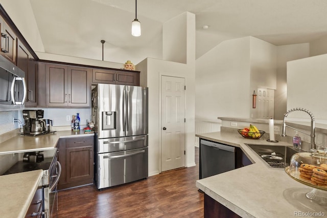 1457 Rosedale St, Castle Rock, CO 80104 - kitchen featuring appliances with stainless steel finishes, a sink, dark brown cabinets, light countertops, and vaulted ceiling
