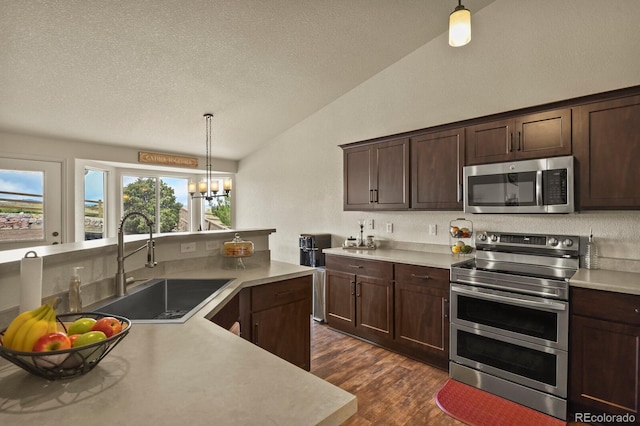 1457 Rosedale St, Castle Rock, CO 80104 - kitchen featuring stainless steel appliances, lofted ceiling, a sink, light countertops, and a textured ceiling
