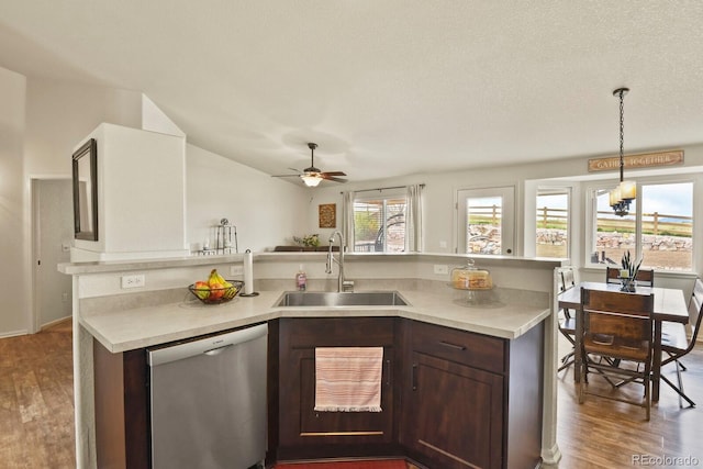 1457 Rosedale St, Castle Rock, CO 80104 - kitchen with stainless steel dishwasher, a sink, light countertops, and wood finished floors