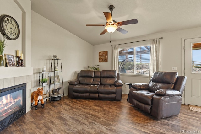 1457 Rosedale St, Castle Rock, CO 80104 - living room with wood finished floors, ceiling fan, a tiled fireplace, and vaulted ceiling