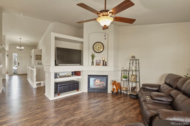 1457 Rosedale St, Castle Rock, CO 80104 - living area featuring wood finished floors, ceiling fan, a chandelier, vaulted ceiling, and a tiled fireplace
