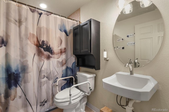 1457 Rosedale St, Castle Rock, CO 80104 - bathroom with toilet, a sink, a textured wall, and curtained shower