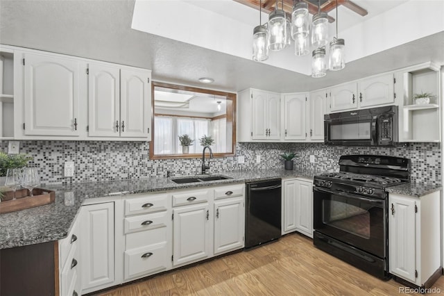 kitchen featuring white cabinetry, sink, and black appliances