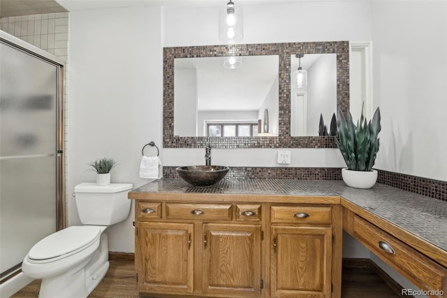 bathroom featuring an enclosed shower, vanity, toilet, and hardwood / wood-style flooring