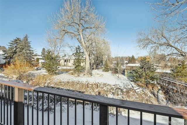 view of snow covered back of property