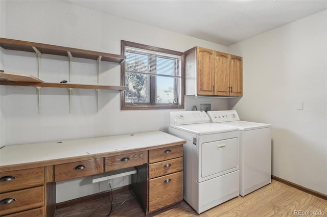 laundry area with light hardwood / wood-style flooring, cabinets, and independent washer and dryer