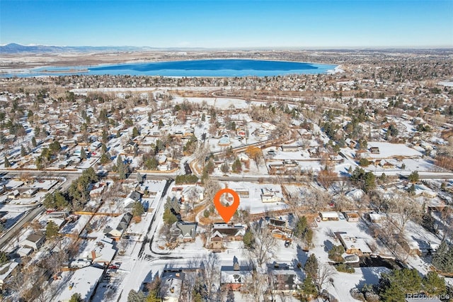 snowy aerial view with a water view