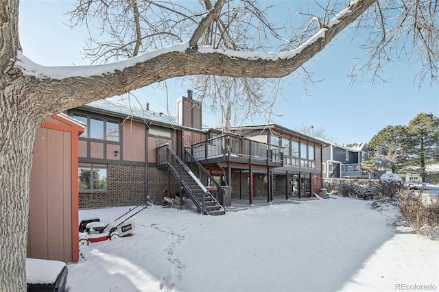 snow covered property featuring a wooden deck