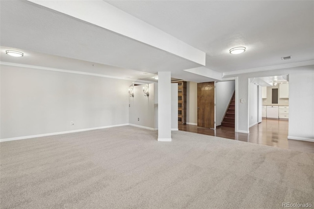 carpeted spare room featuring ornamental molding